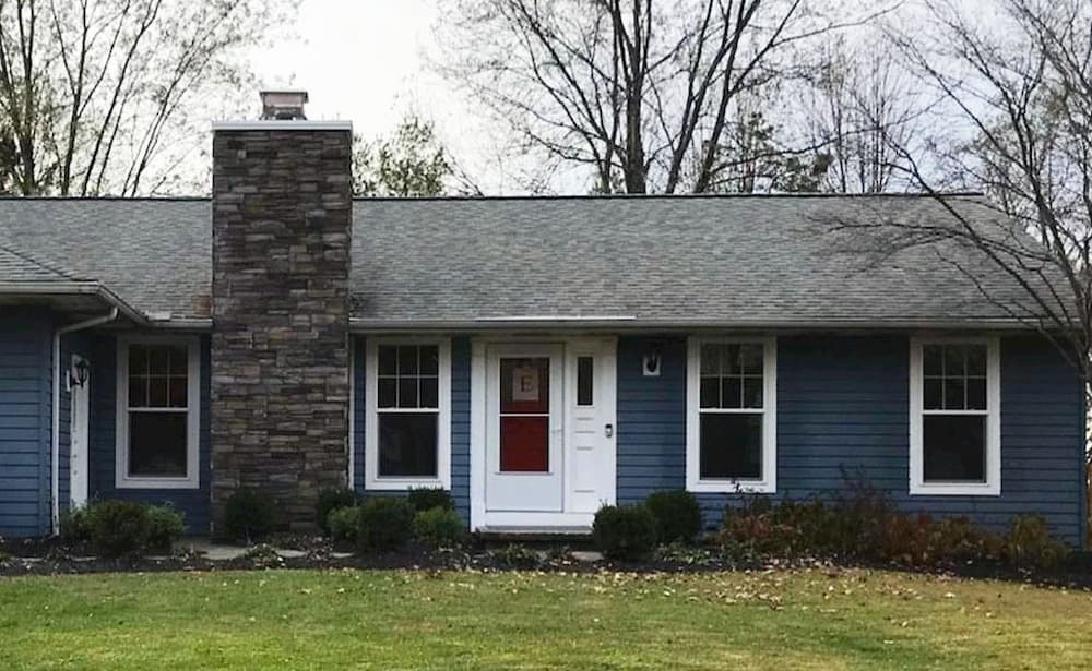Front exterior of blue home with all-new double-hung windows