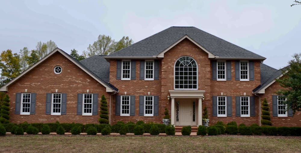 Exterior of brick home with all-new wood windows
