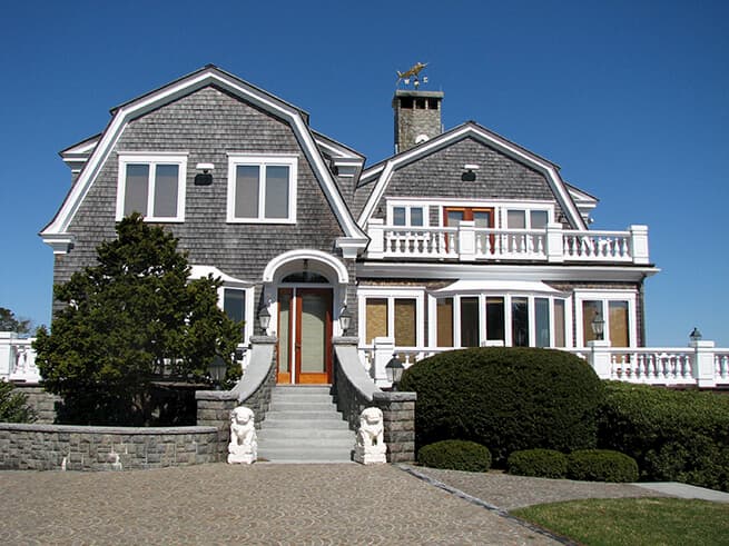 Exterior view of shingle-style home with all-new Pella casement windows