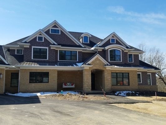 street view of new construction home in Dubuque featuring Pella's wood double hung windows