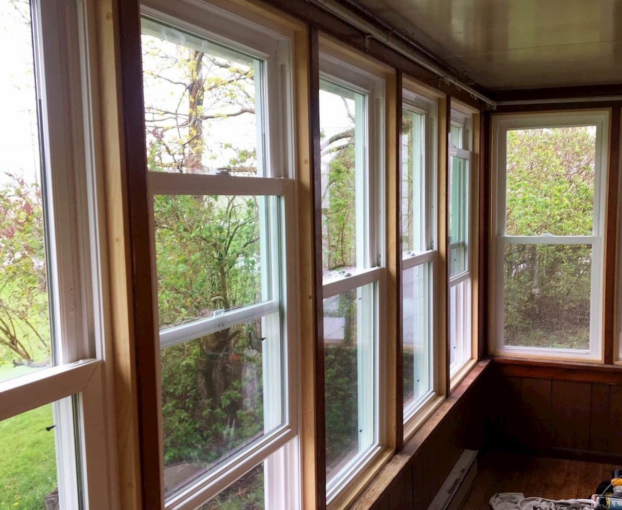 Interior view of new vinyl double-hung windows on a sun porch