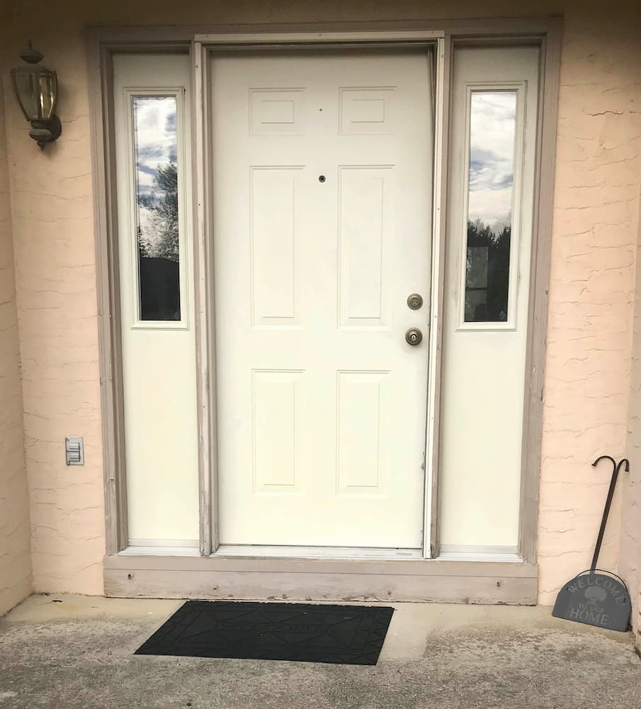 Old ivory entry door system on brick home