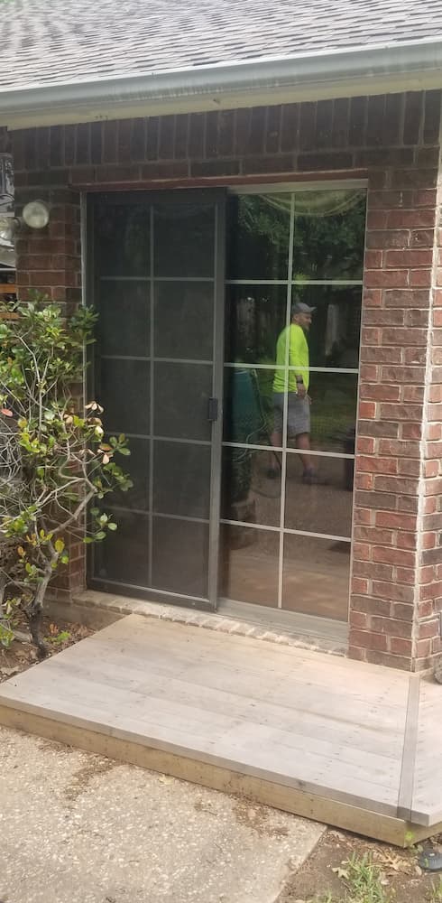 Old sliding patio door on a brick home