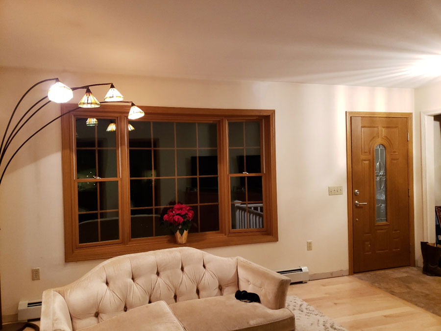 Interior of a home in Essex, VT, with a new bay window and wood front door