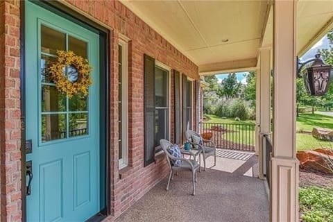Teal front door with brick exterior