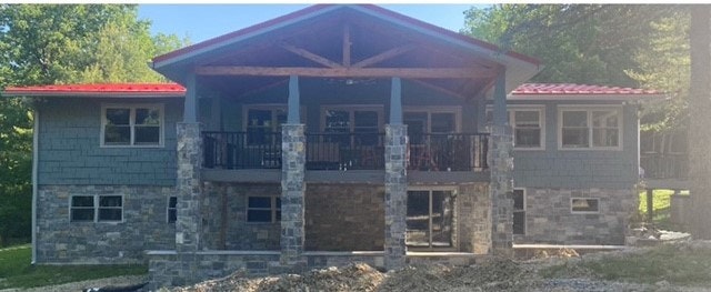 front of updated home featuring sky gray windows that match its stone details