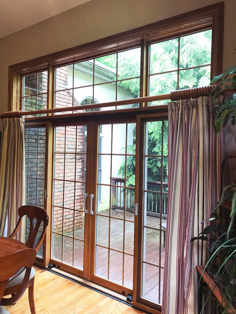 Interior view of double sliding patio doors made of wood with traditional grille pattern