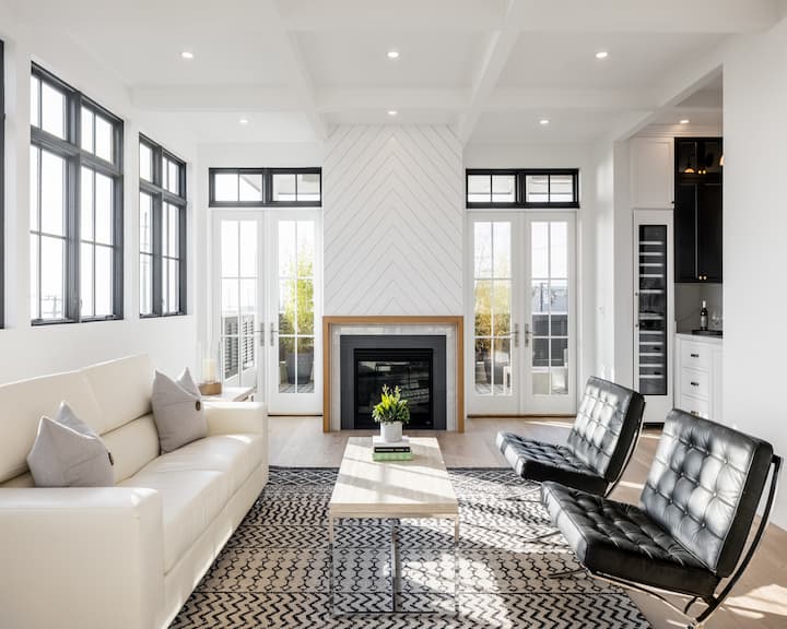 Living room with black windows and white hinged patio doors