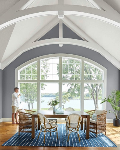 Dining room with large special shape windows overlooking lake