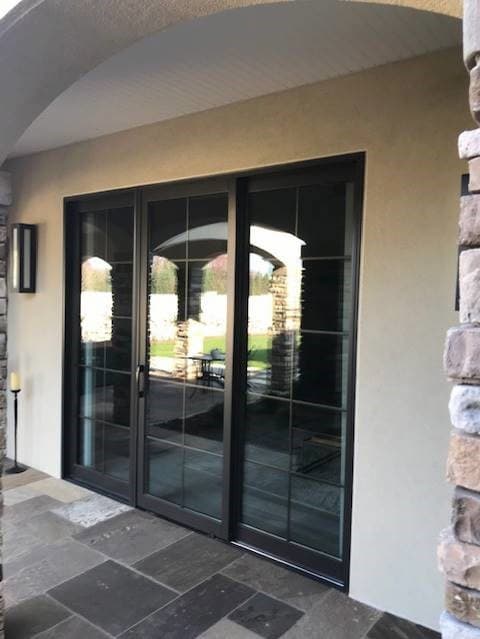 Exterior view of wood sliding patio door with traditional grille pattern