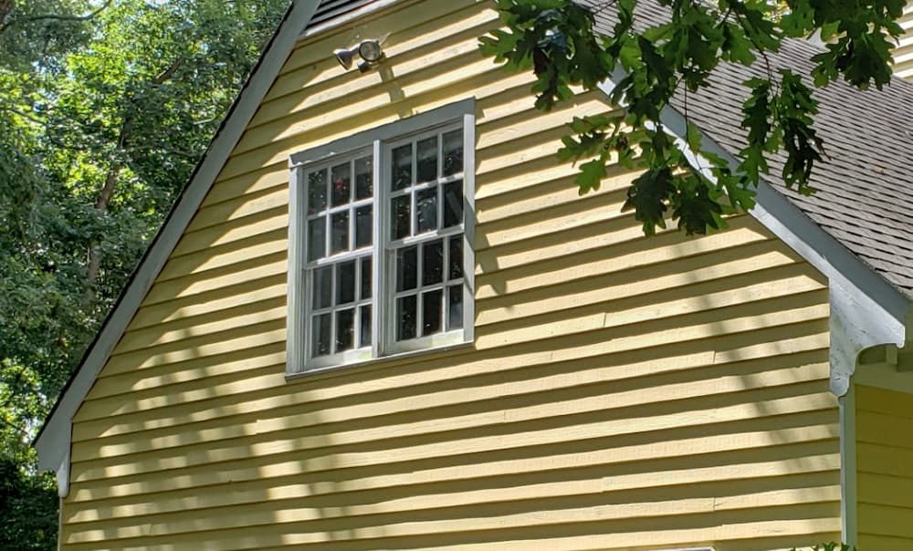 Two vinyl double-hung windows over a garage