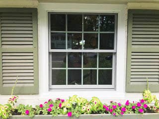 New white double-hung window with traditional grille pattern