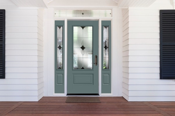 a green door with three panels on a white home's exterior
