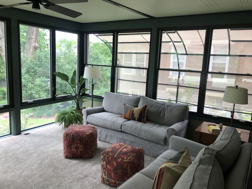 Couches on sun porch with new wood double-hung and casement windows