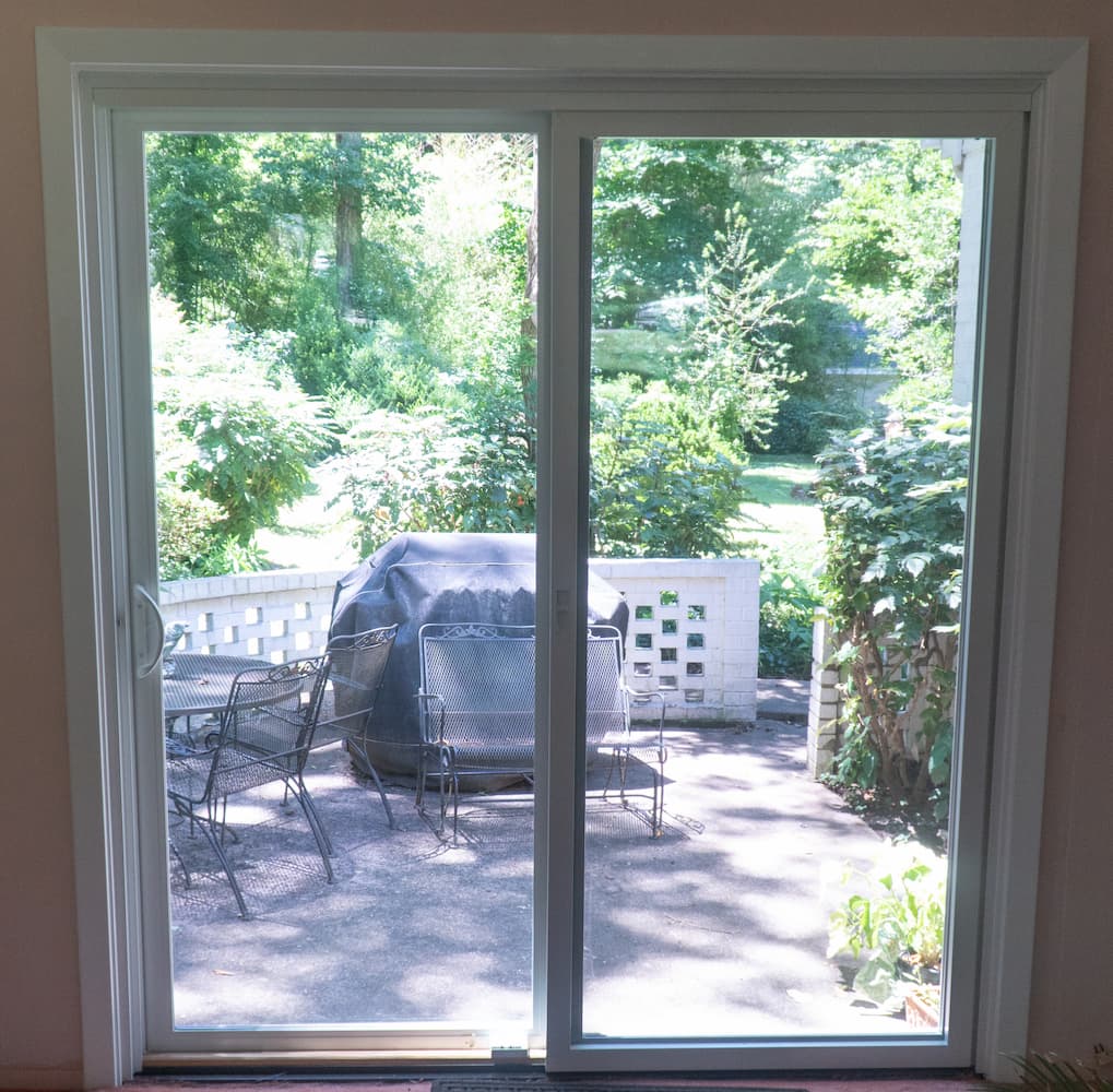 New vinyl sliding patio door with white trim
