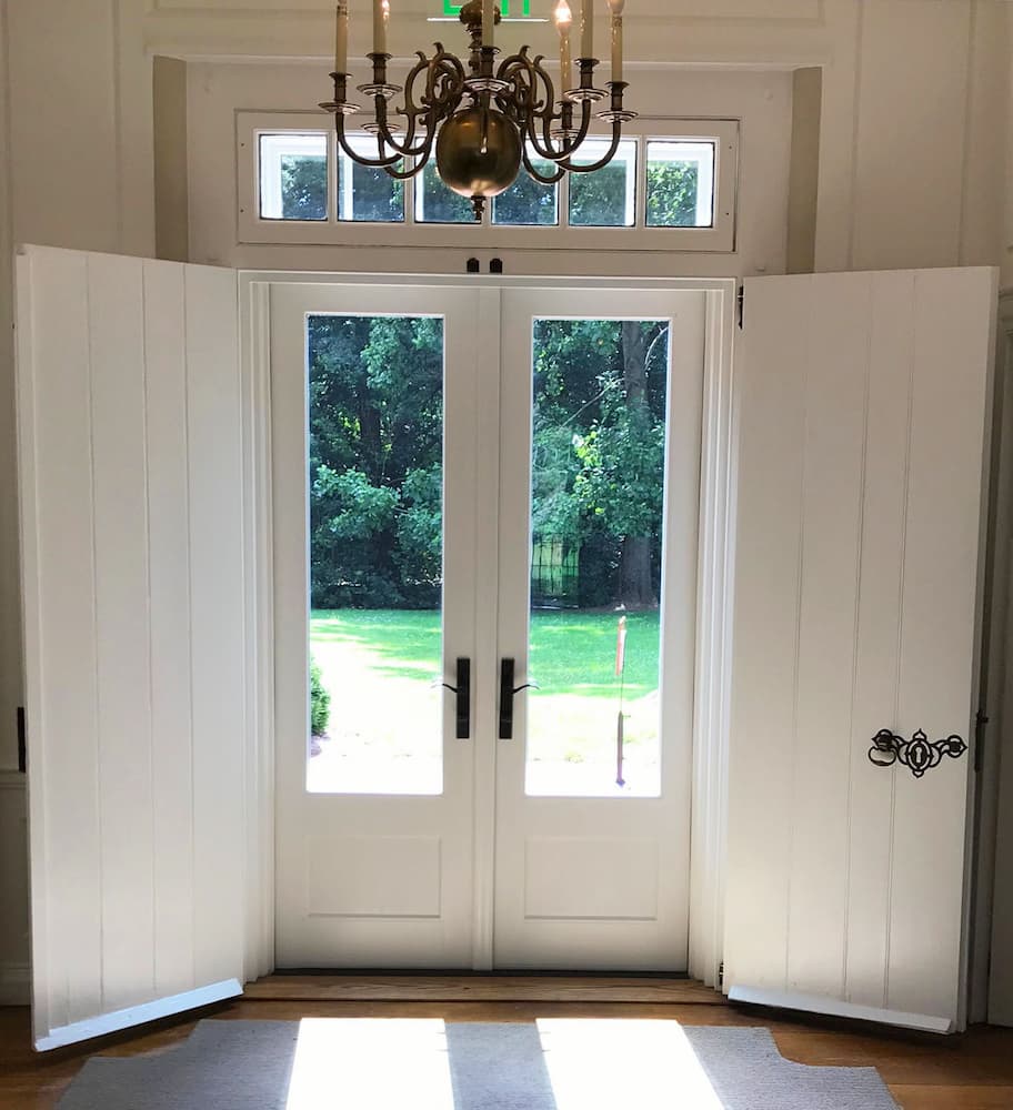 Interior view of new French patio doors and transom window overlooking back yard