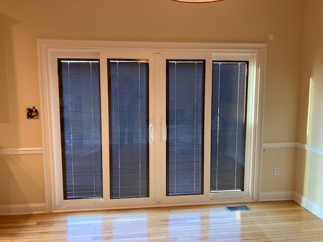 New white multi-slide patio doors with between the glass blinds drawn