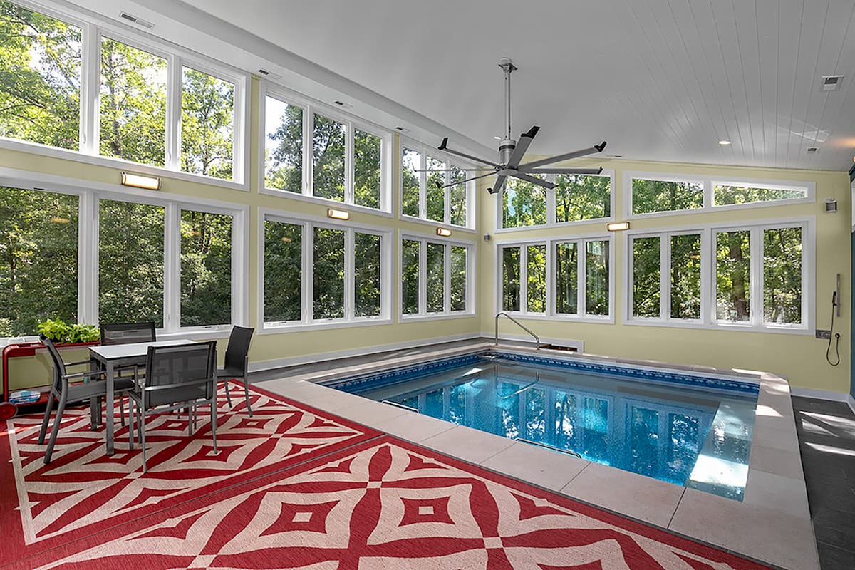 Interior view of pool house with two walls of white vinyl windows