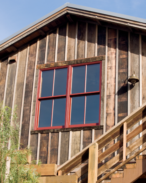 red windows against natural wood siding