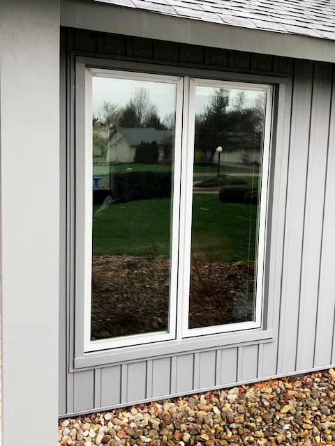 New fiberglass casement windows against gray siding