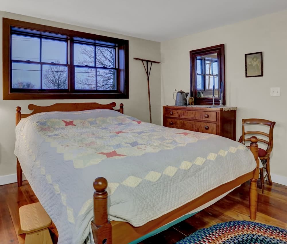 Interior view of bedroom with small wood double-hung windows
