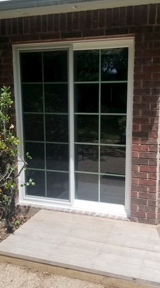 Exterior view of new white vinyl sliding patio door