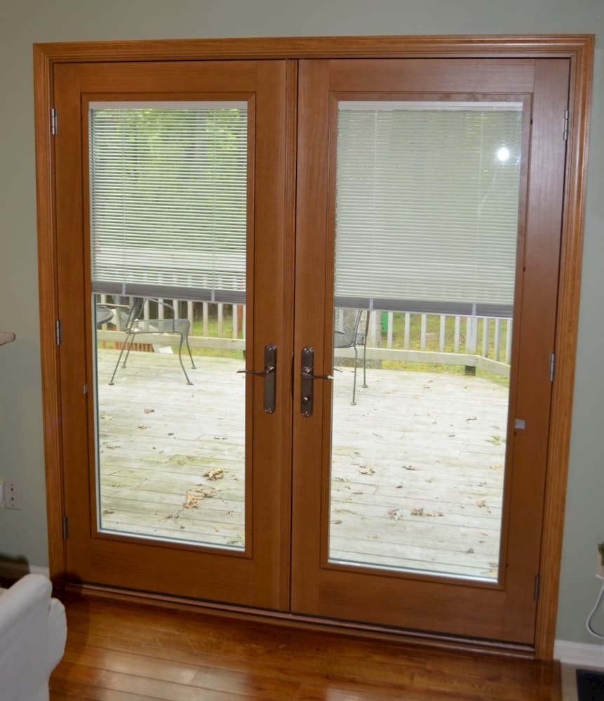 Interior view wood double French doors with between-the-glass blinds
