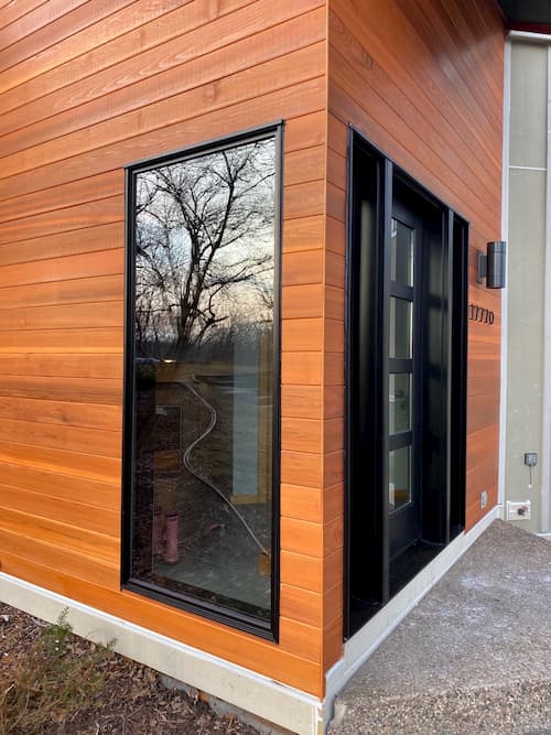 Minnetonka home angled close-up view of casement window and fiberglass door