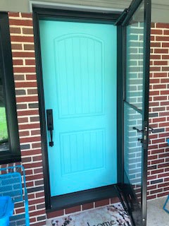 New turquoise fiberglass entry door with storm door