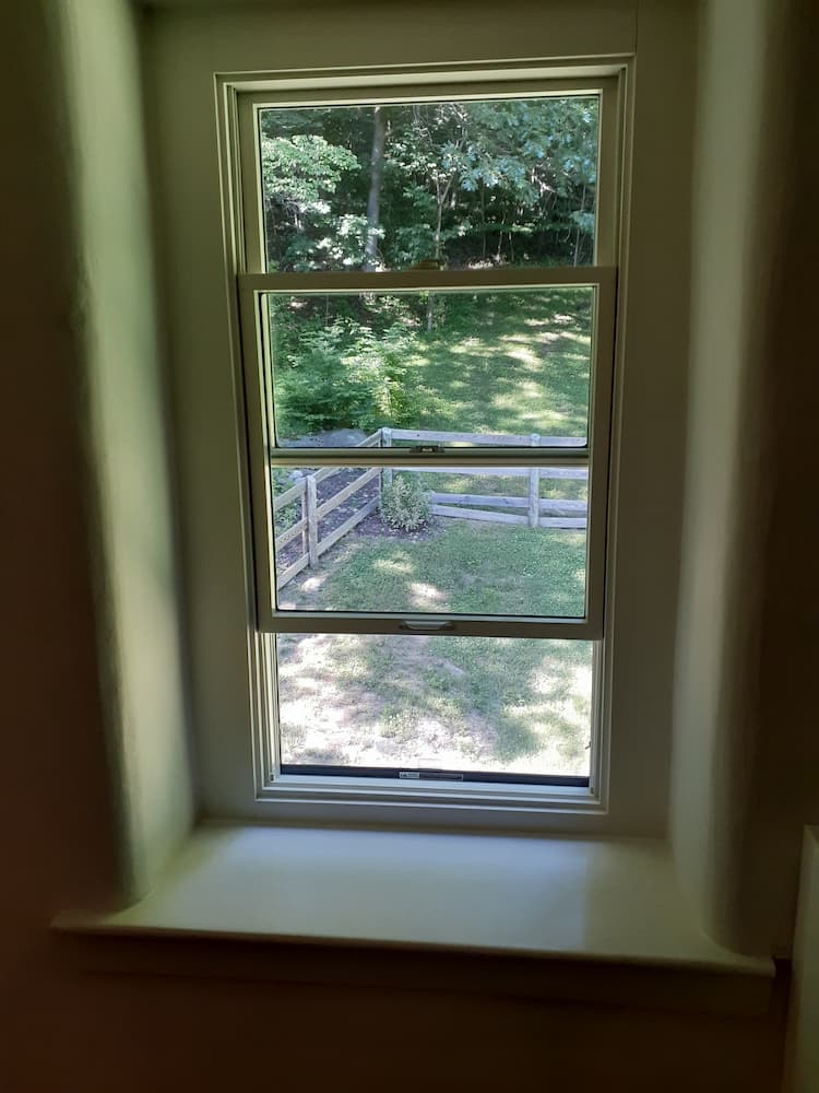 Half-opened white double-hung window 