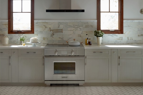 varied textures in a white kitchen with a marble backsplash