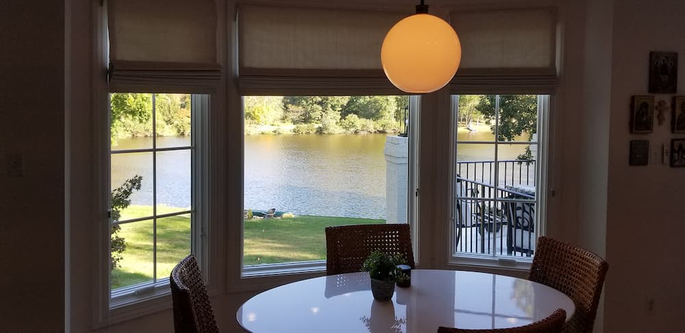 Dining room view from new bay windows looking out onto backyard and lake 