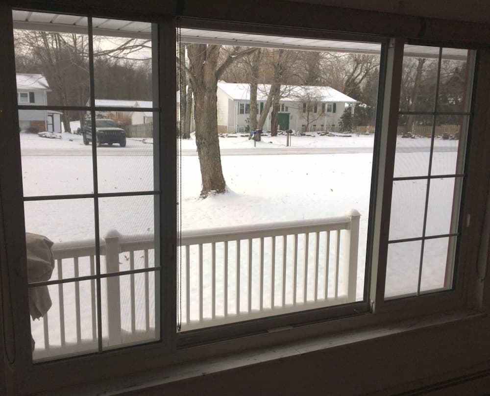 Looking through a picture and two casement windows out onto a snowy landscape