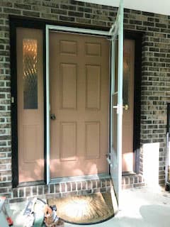 Old brown entry door system with storm door