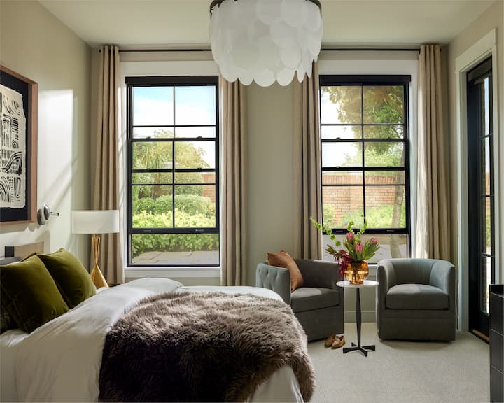 Interior view of two black wood double-hung windows in bedroom
