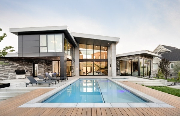 Poolside exterior of modern home with outside window trim