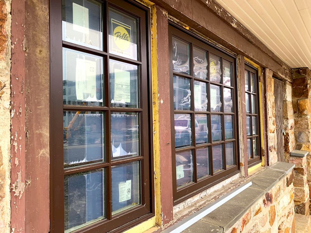Close up of Pella brown wood windows with grilles on historic building