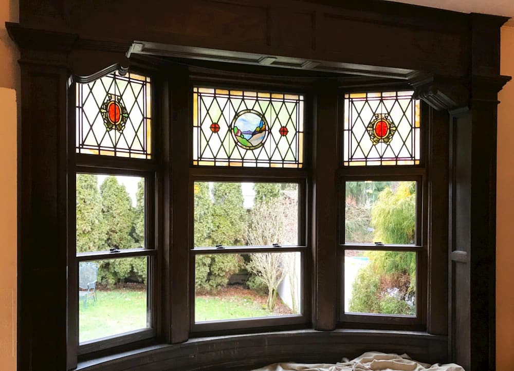 Interior view of new wood bay window with stained glass