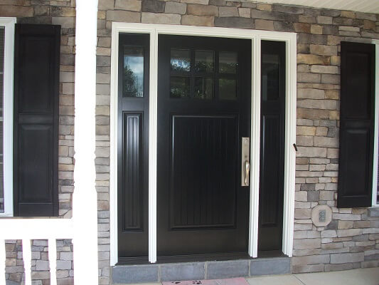 Black Craftsman front door with sidelights and white trim
