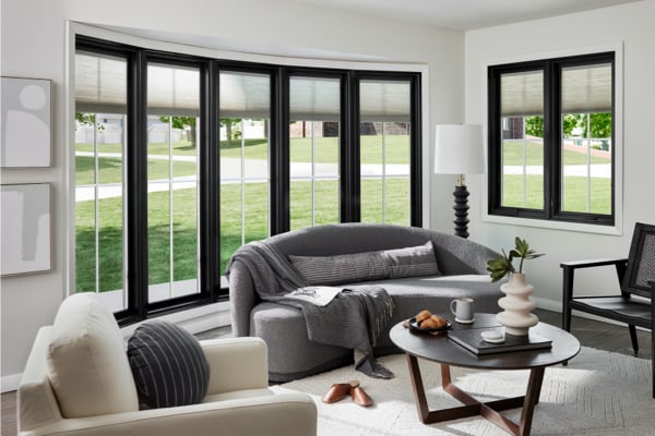 Bow windows with bold black frames and neutral grille patterns