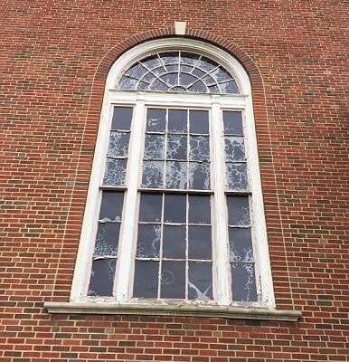 old window with peeling paint and wood rot