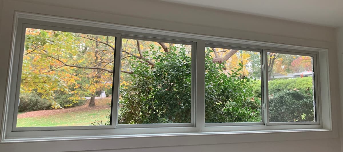 Interior View Of White Sliding Fiberglass Windows On White Wall.