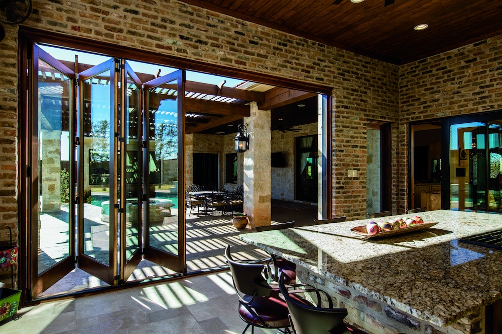 Bifold patio doors connect dining room to outdoor patio area
