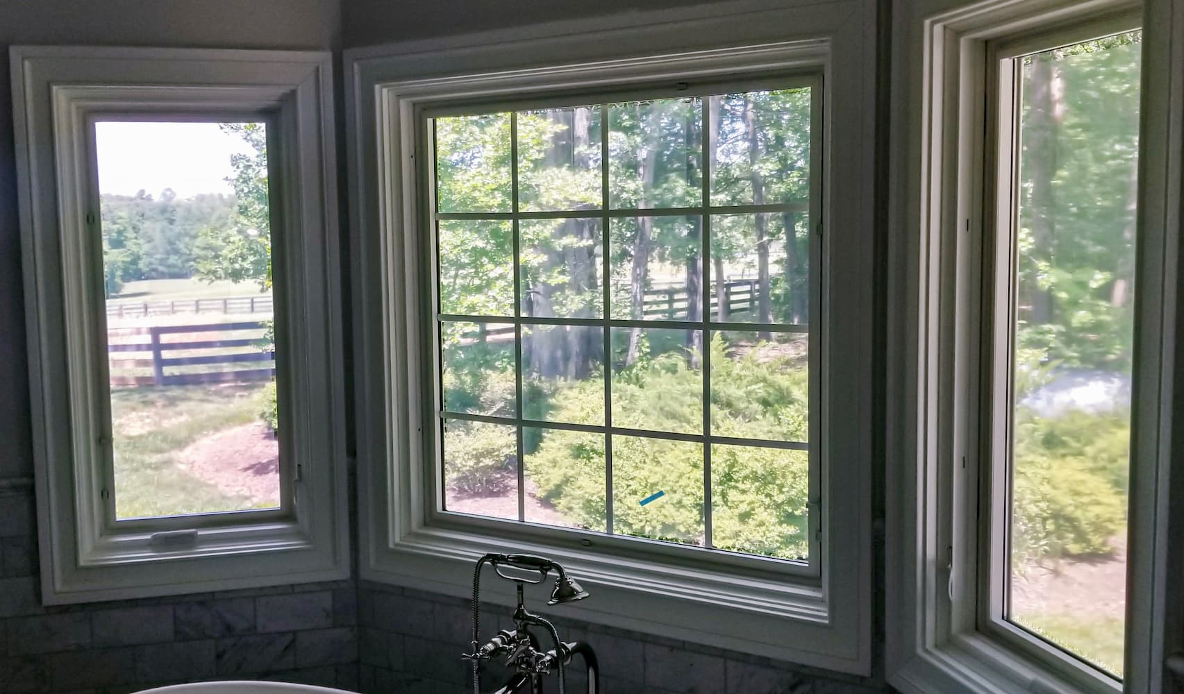 Two wood casement windows flanking a wood picture window with traditional grille pattern