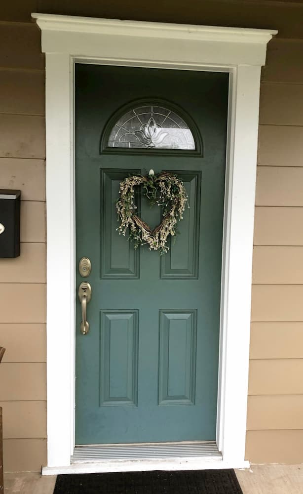 Old green entry door with wreath