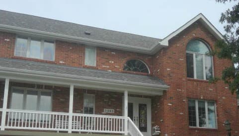 Exterior view of brick home with old windows