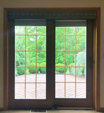 Interior view of wood sliding patio door with traditional grille pattern