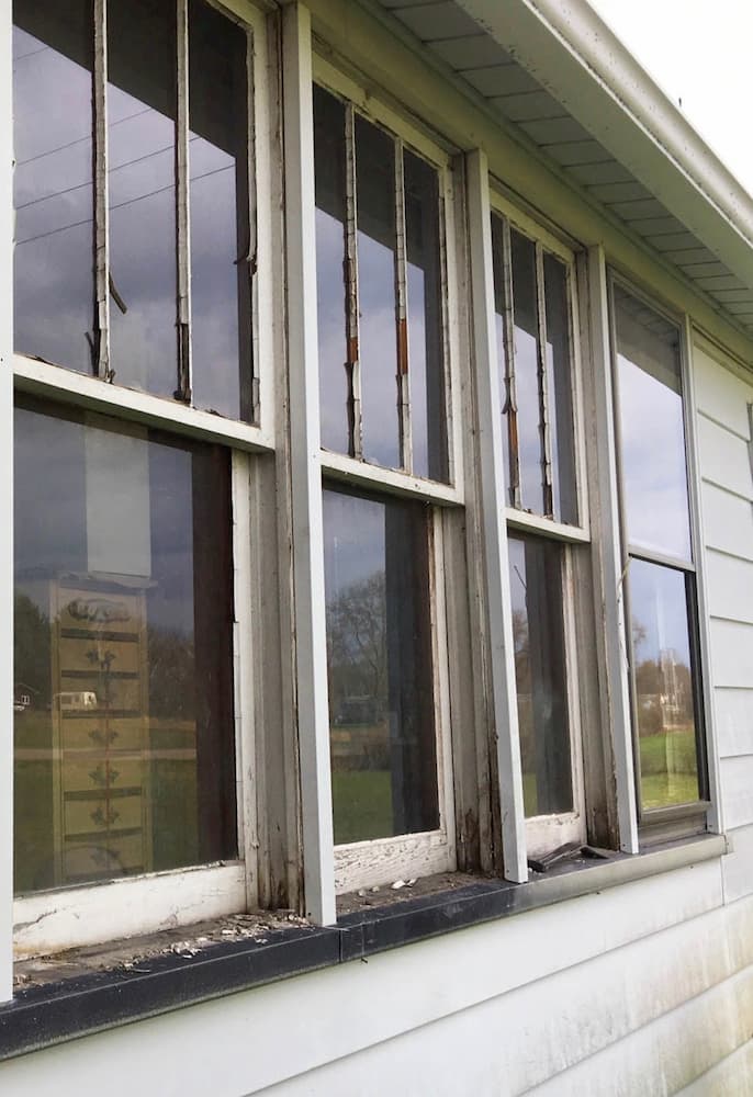 Old, damaged double-hung windows