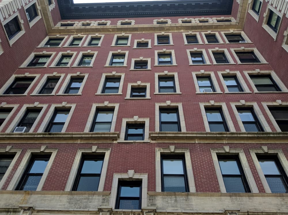 Brick apartment building with all new black wood double-hung windows