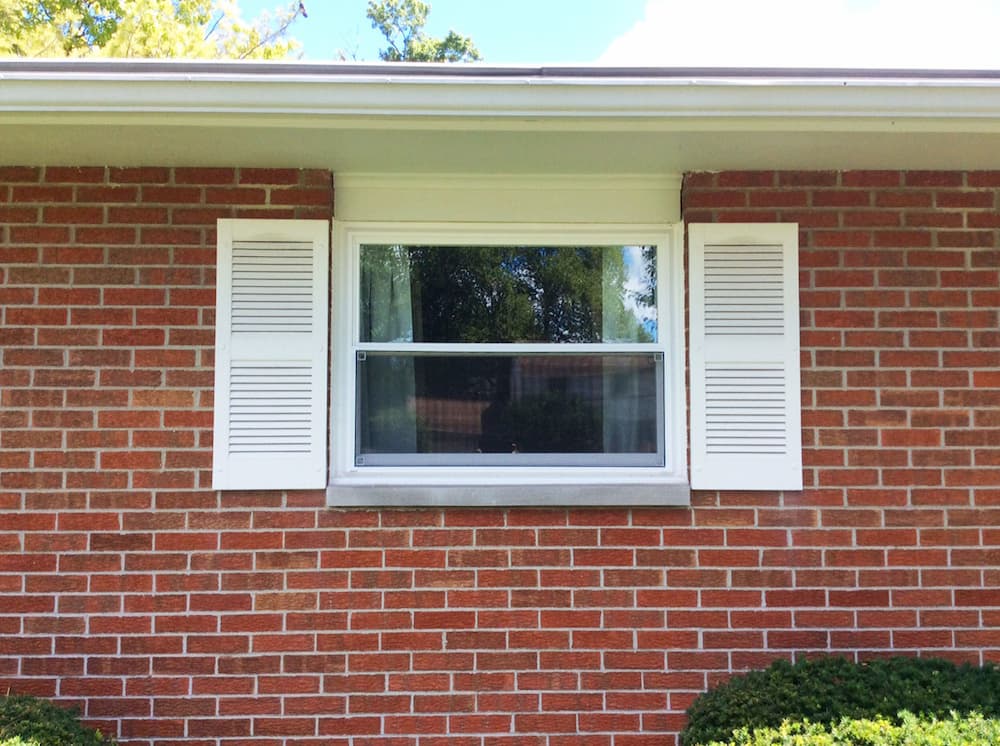 New vinyl double-hung window on a red brick home